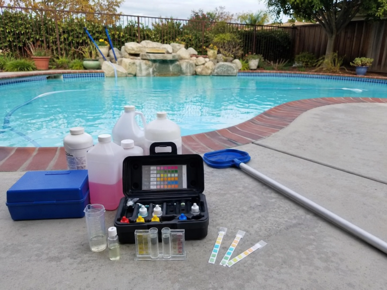 Pool water testing and chemical balancing service at a residential pool in Hayward, California
